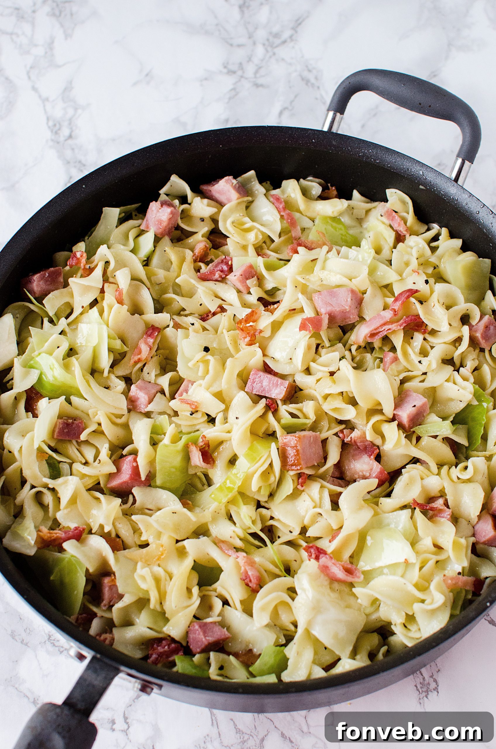 A close-up of a serving of Haluski, emphasizing the tender pieces of ham and savory cabbage.