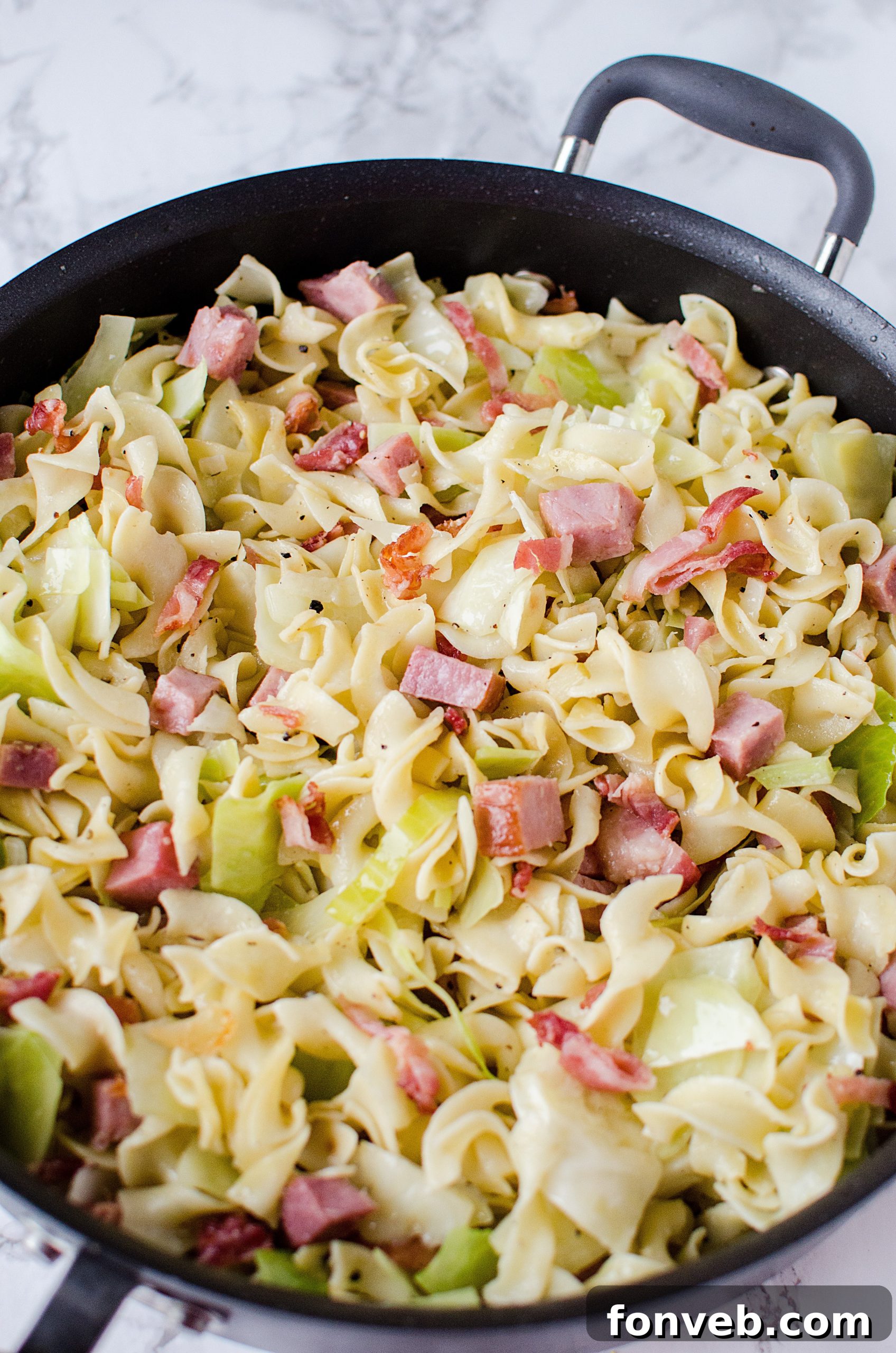 A side view of the Haluski dish, showing the depth of ingredients and appealing texture.