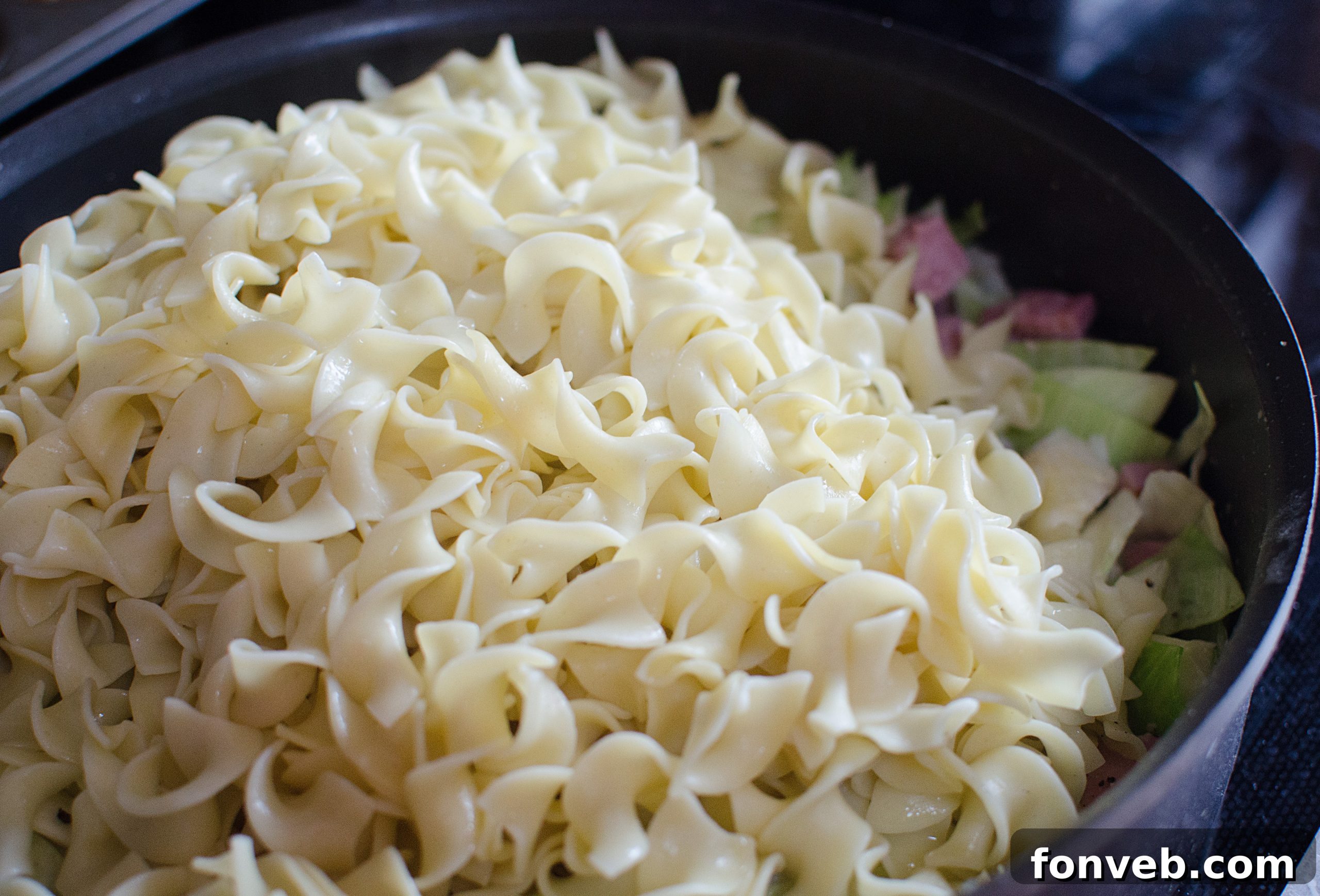 Boiling egg noodles in a pot, preparing them for the Haluski dish.