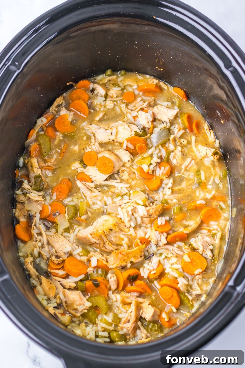 white rice turkey soup in a slow cooker sitting on counter
