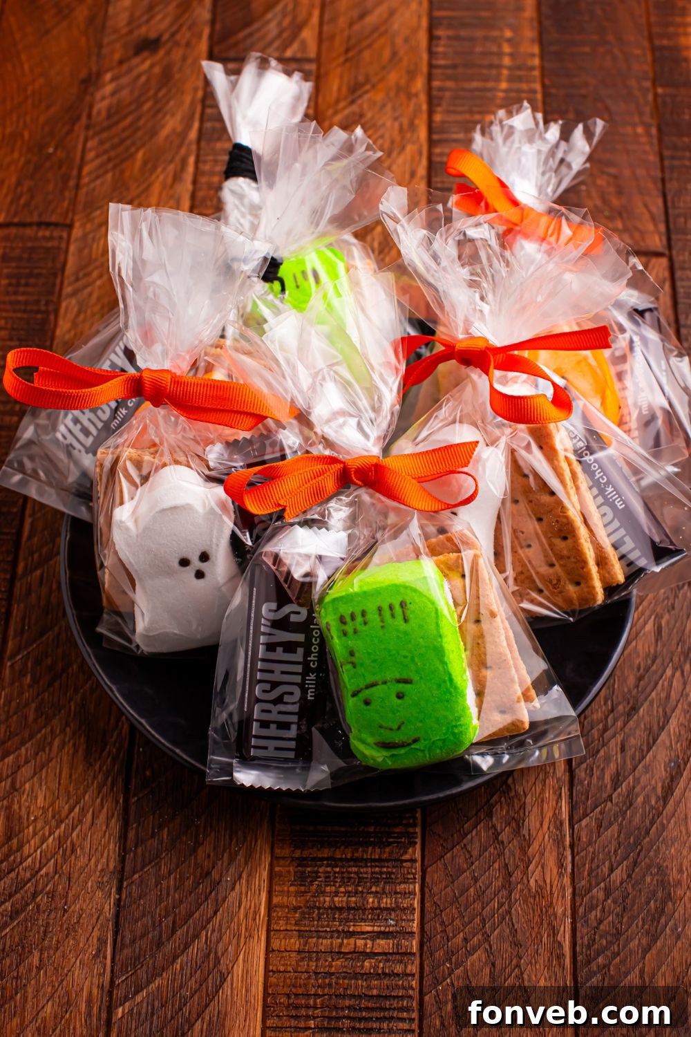 Spooky S'mores Kits 10 Halloween Smores Gift Bags on a black plate on table