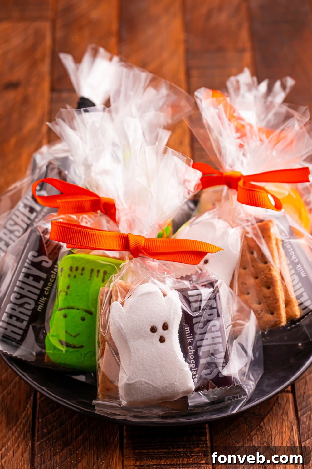 Spooky S'mores Kits 12 Halloween Smores Gift Bags in a black bowl on a wooden table