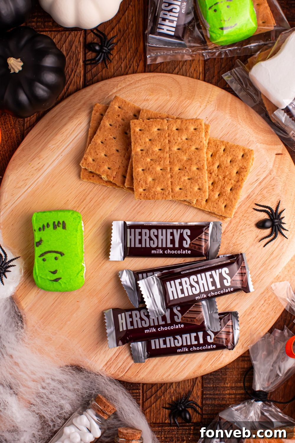 Spooky S'mores Kits 5 ingredients for Halloween Smores Gift Bags on table with Halloween decor items around it on table