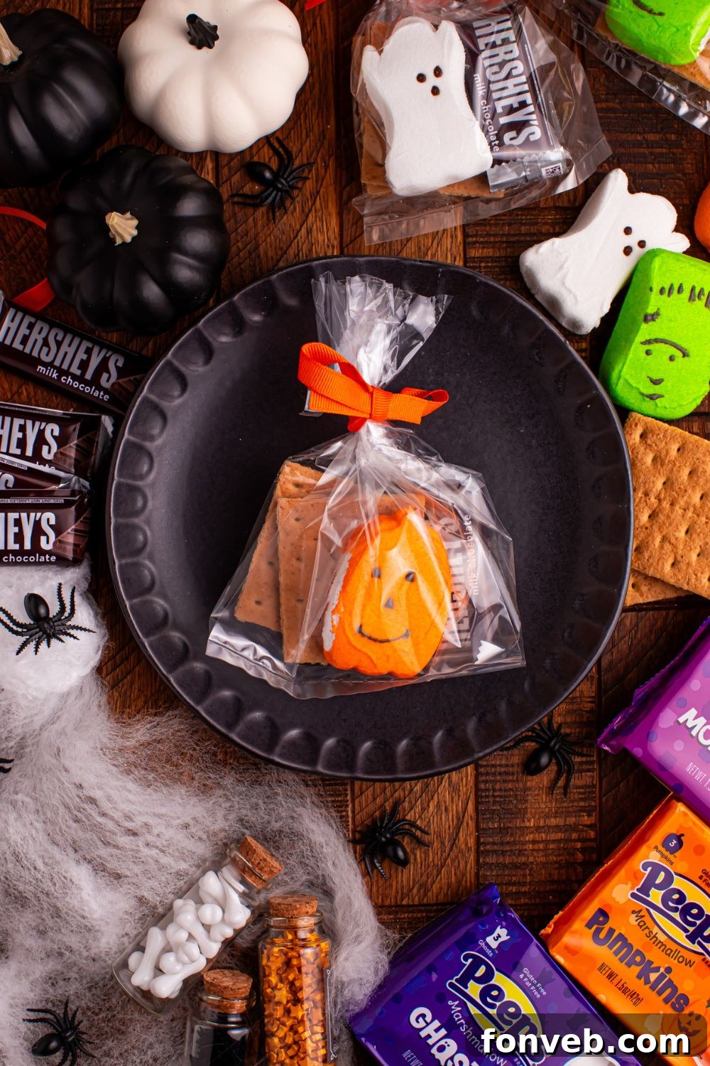 Spooky S'mores Kits 8 Halloween Smores Gift Bag on a plate on table with marshmallows and chocolate around it on table