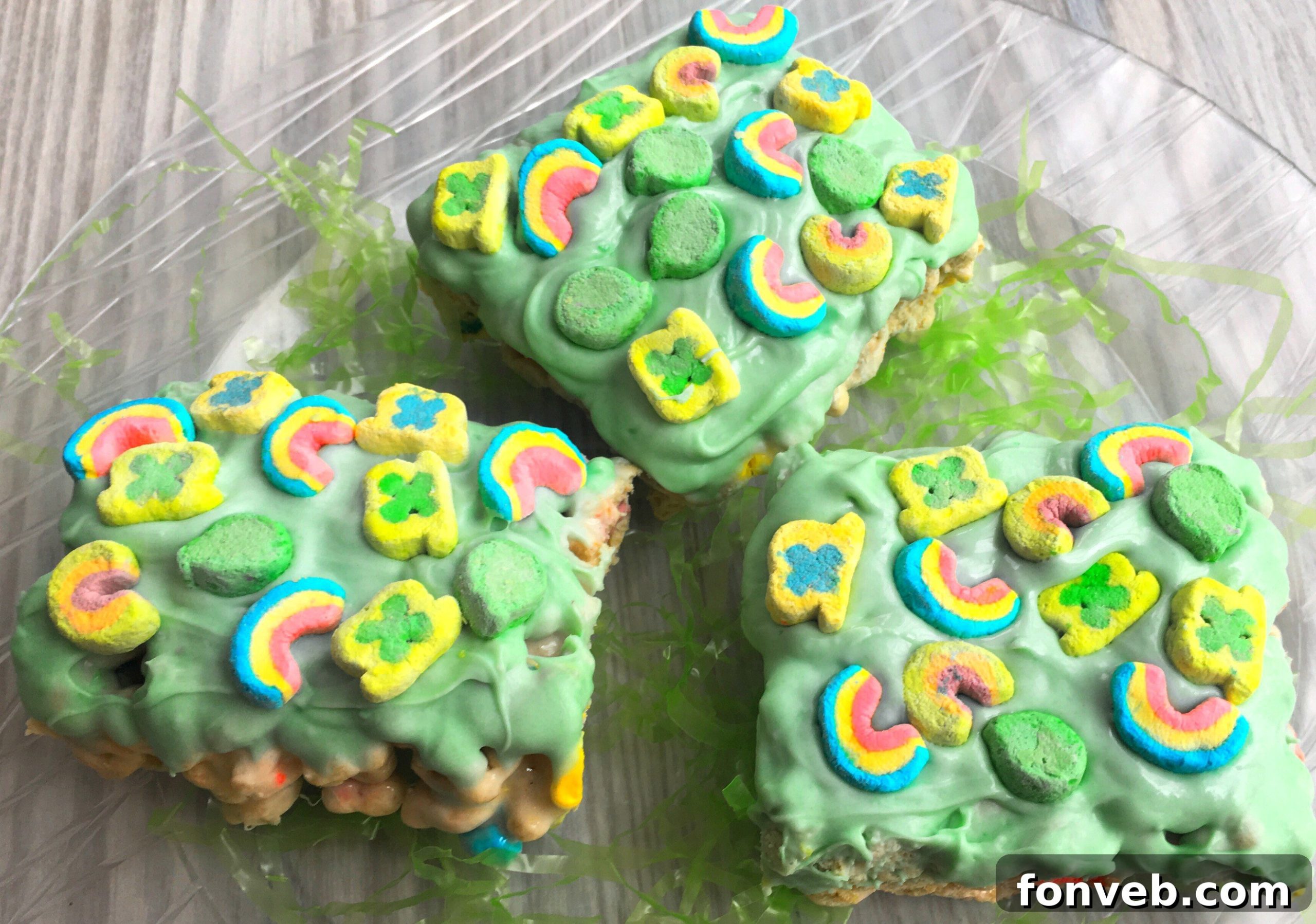 Multiple Lucky Charms Cereal Bars arranged neatly, some dipped in green chocolate, ready for serving.