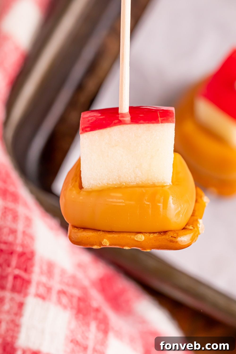 close up of a Caramel Apple Pretzel Bite on a stick 