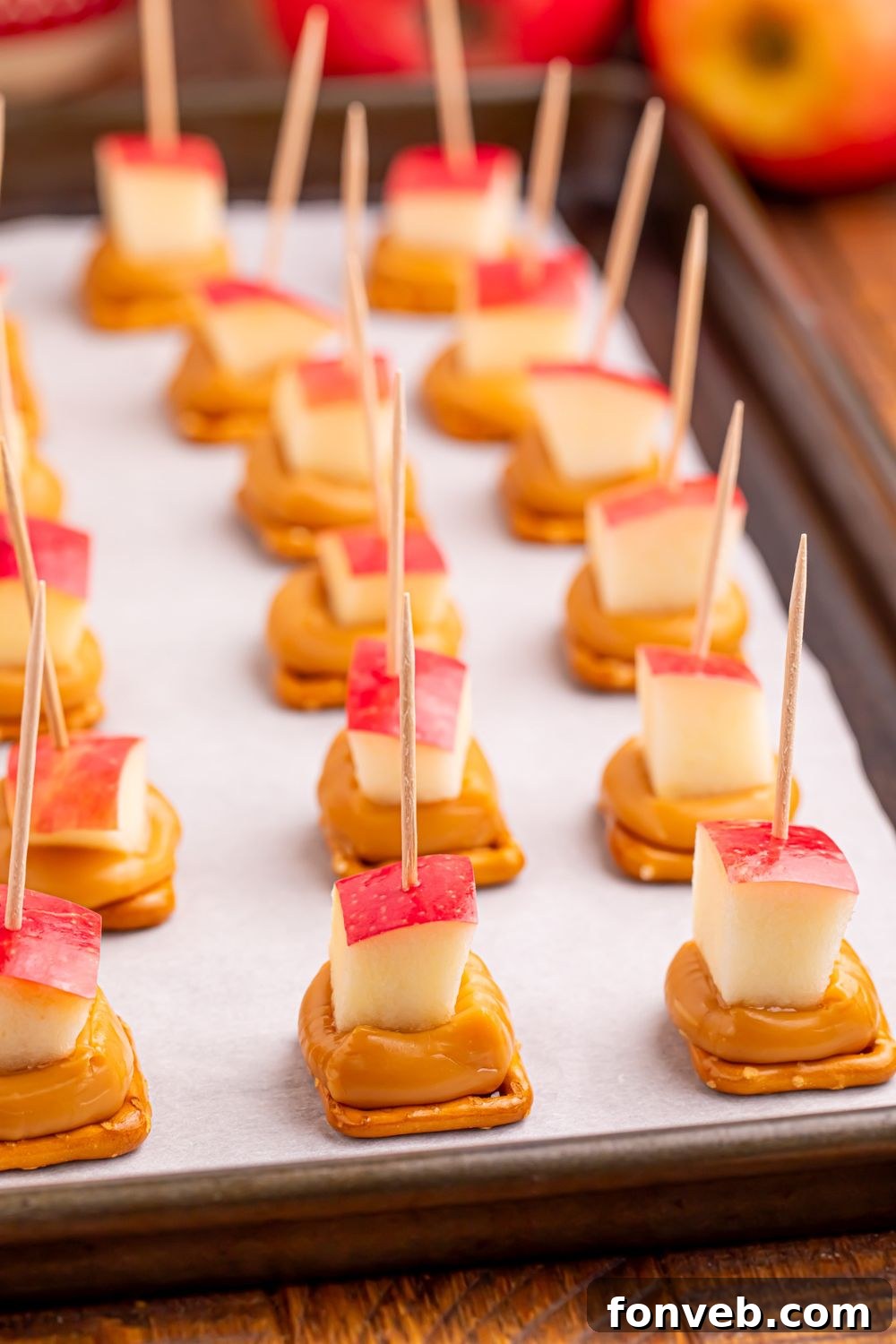 Caramel Apple Pretzel Bites on a baking sheet sitting on table 