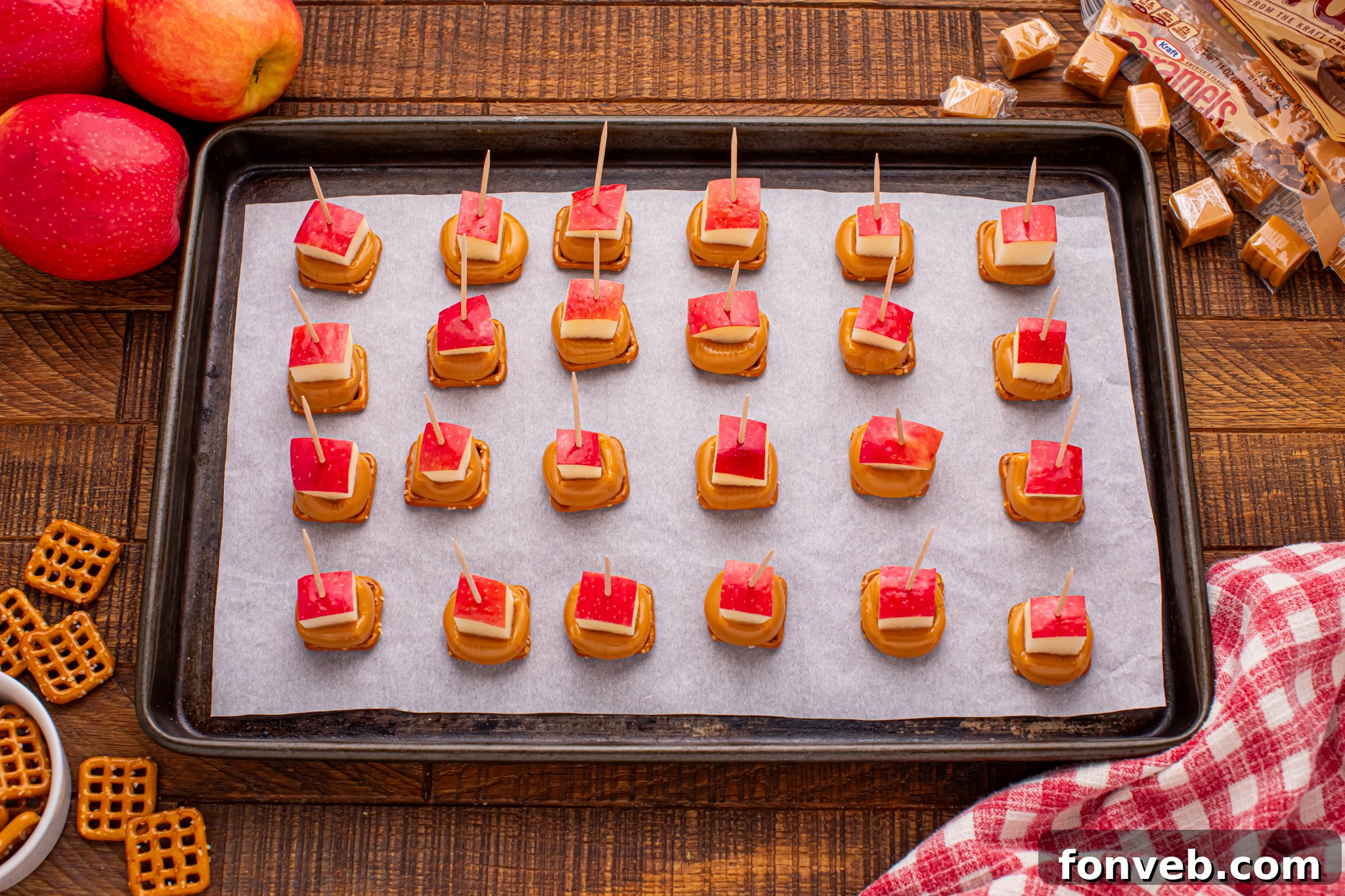 Caramel Apple Pretzel Bites on a cookie sheet with toothpick in each