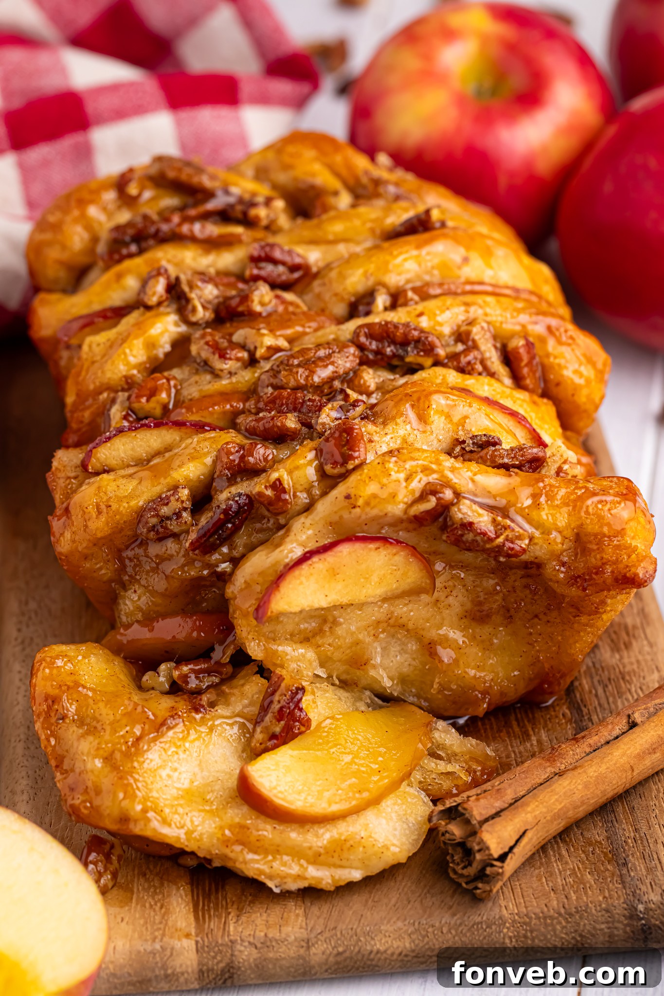 Apple Pie Monkey Bread 2 Apple Pie Pull Apart Bread sitting on table topped with nuts and caramel sauce
