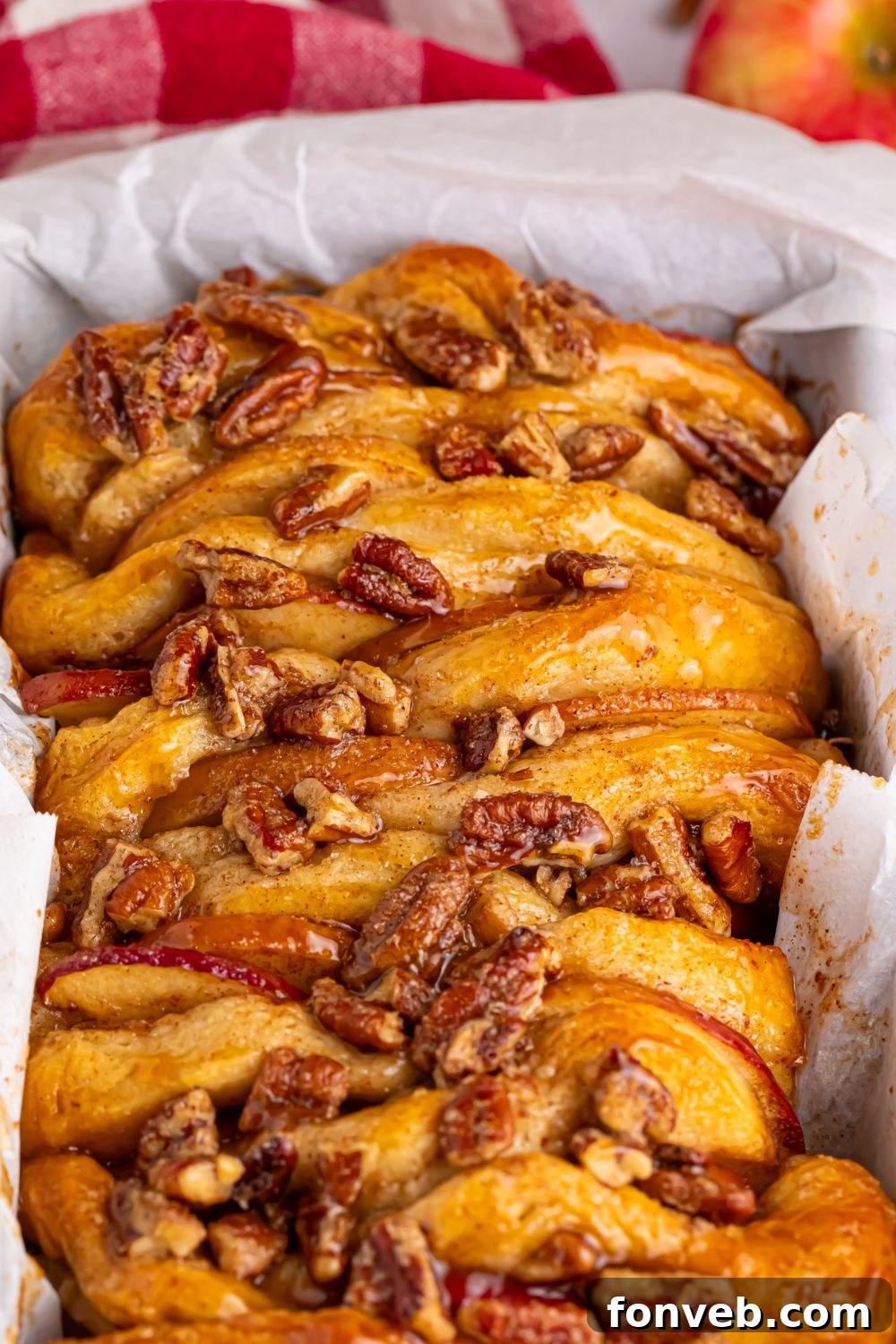 Apple Pie Monkey Bread 16 Apple Pie Pull Apart Bread in a pan with a close up of nuts on top