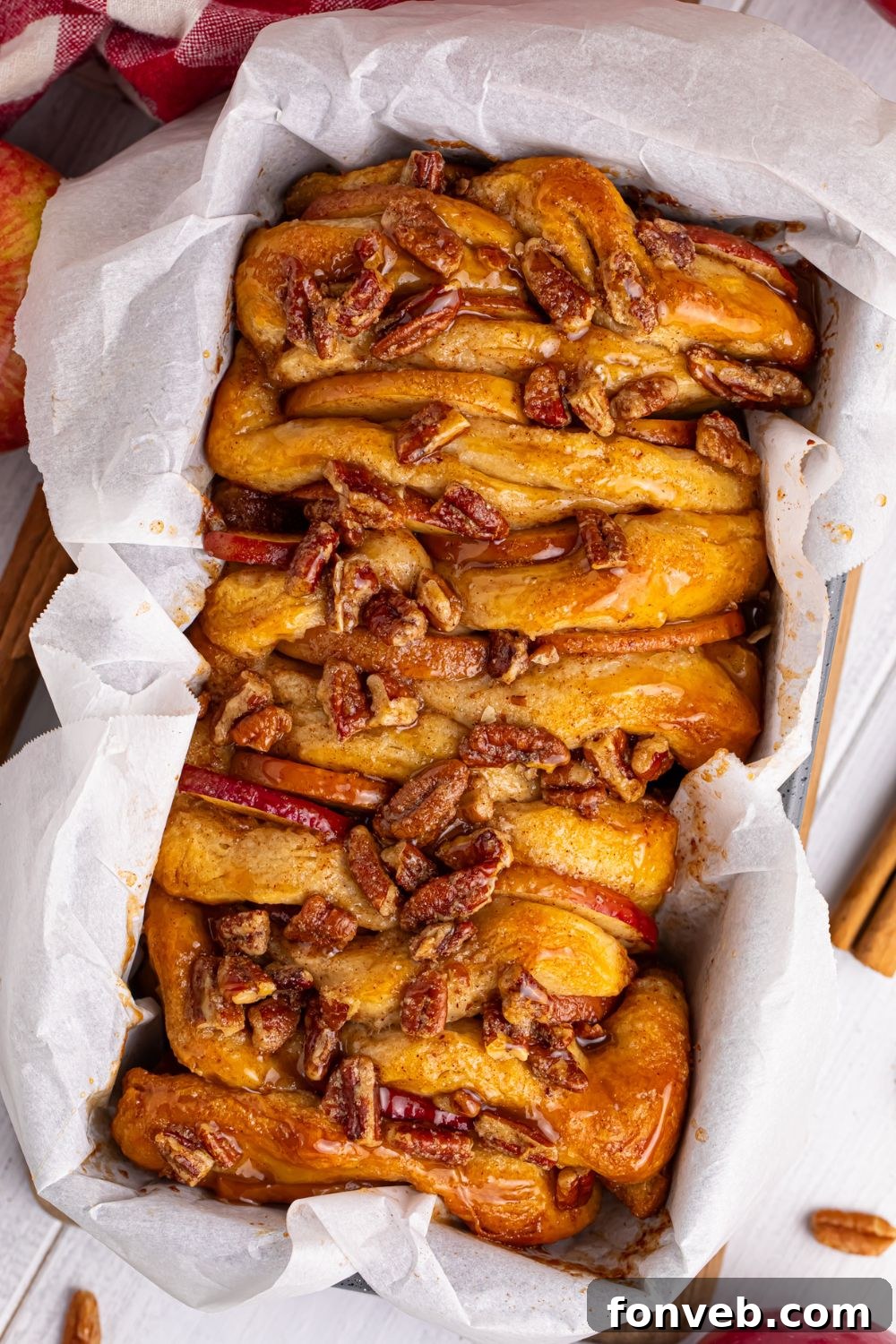 Apple Pie Monkey Bread 17 Apple Pie Pull Apart Bread on table in a pan with parchment paper on the sides