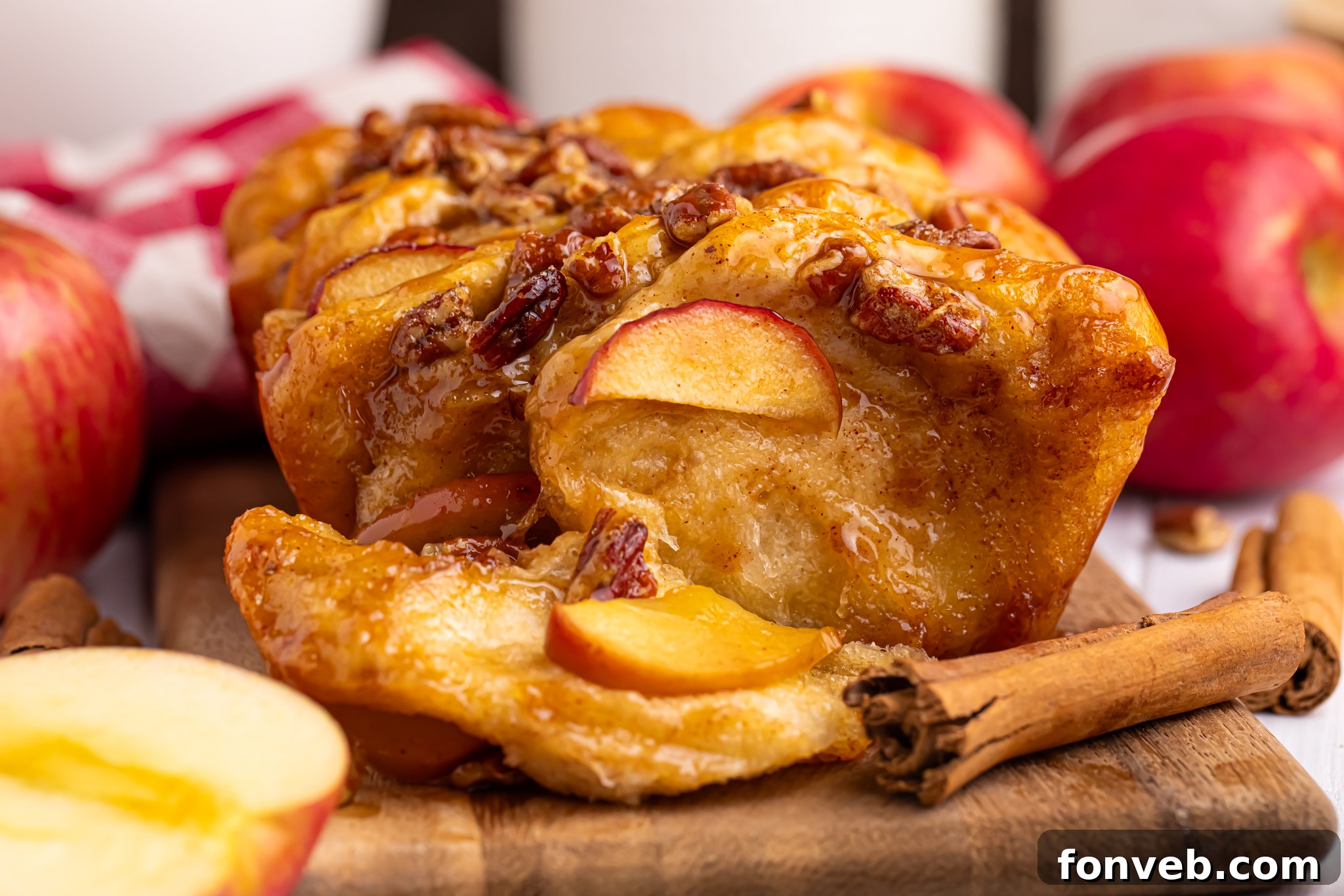 Apple Pie Monkey Bread 20 apple pie pull-apart bread with a slice removed on a wooden board