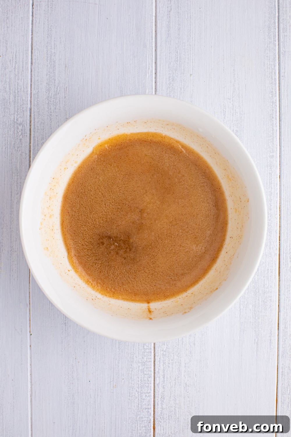 Apple Pie Monkey Bread 6 cinnamon sugar mixture in a white bowl on table