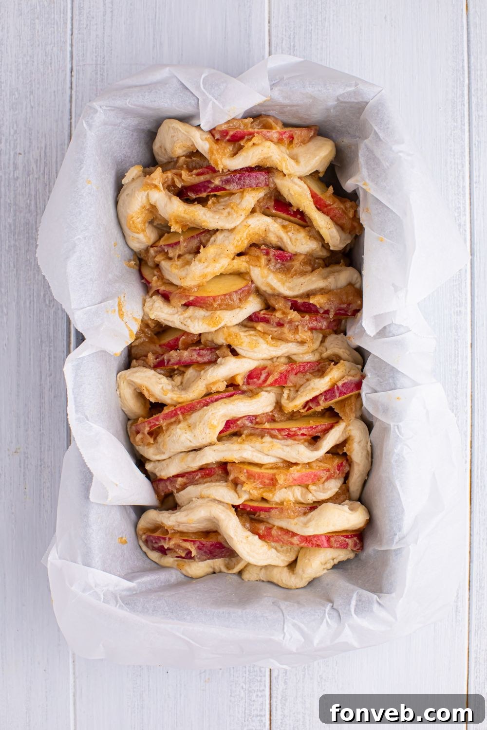 Apple Pie Monkey Bread 10 Apple Pie Pull Apart Bread in the loaf pan full of the cinnamon mixture and apples in between layers of dough