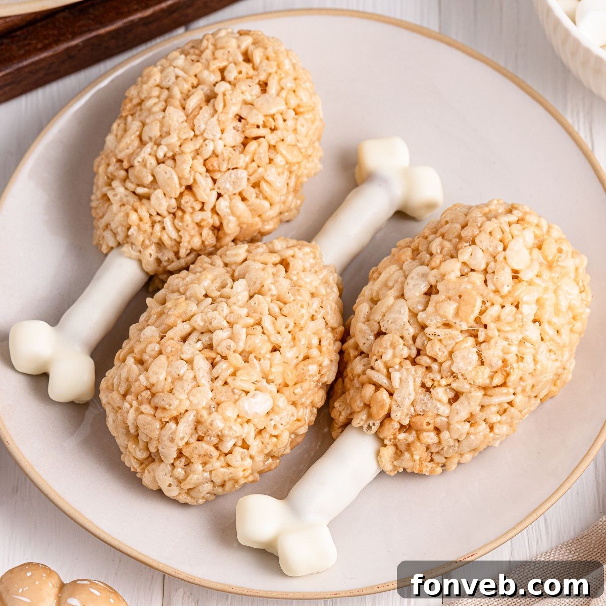 Festive Rice Krispie Drumsticks 15 A single, perfectly crafted Rice Krispie Treat Turkey Leg resting on a clean white plate, ready for indulgence.