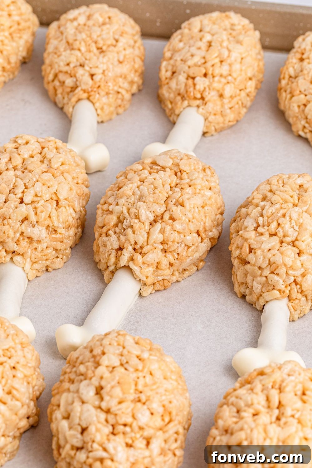 Festive Rice Krispie Drumsticks 3 A pristine white tray showcasing a collection of perfectly shaped Rice Krispie Treat Turkey Legs, ready to be served or admired.