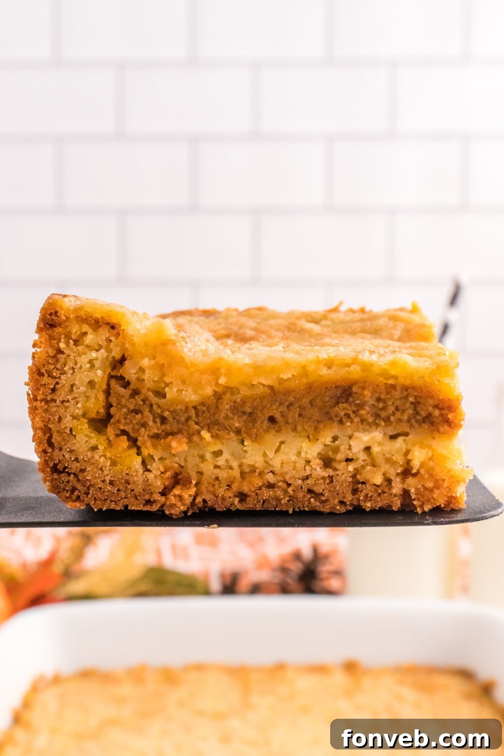 Harvest Pumpkin Pie Delight 12 Several slices of Pumpkin Pie Cake neatly arranged on a spatula, ready to be served, highlighting their inviting layers.