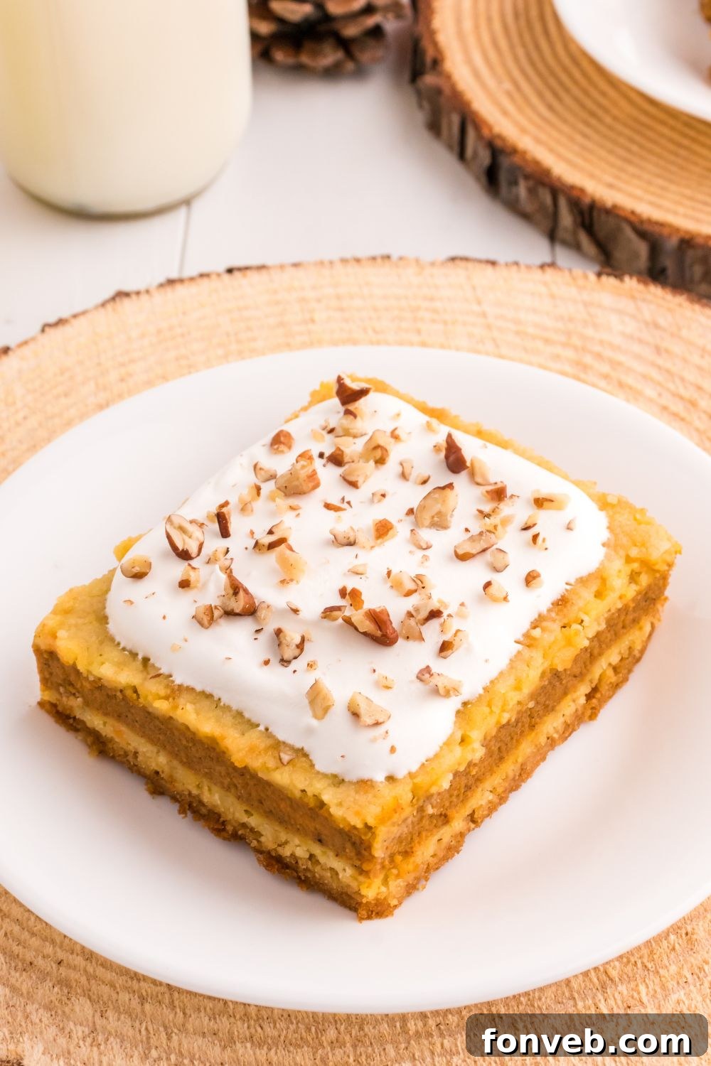 Harvest Pumpkin Pie Delight 15 A generously sized plate featuring a delightful slice of layered pumpkin cake, presented beautifully on a rustic wooden table.