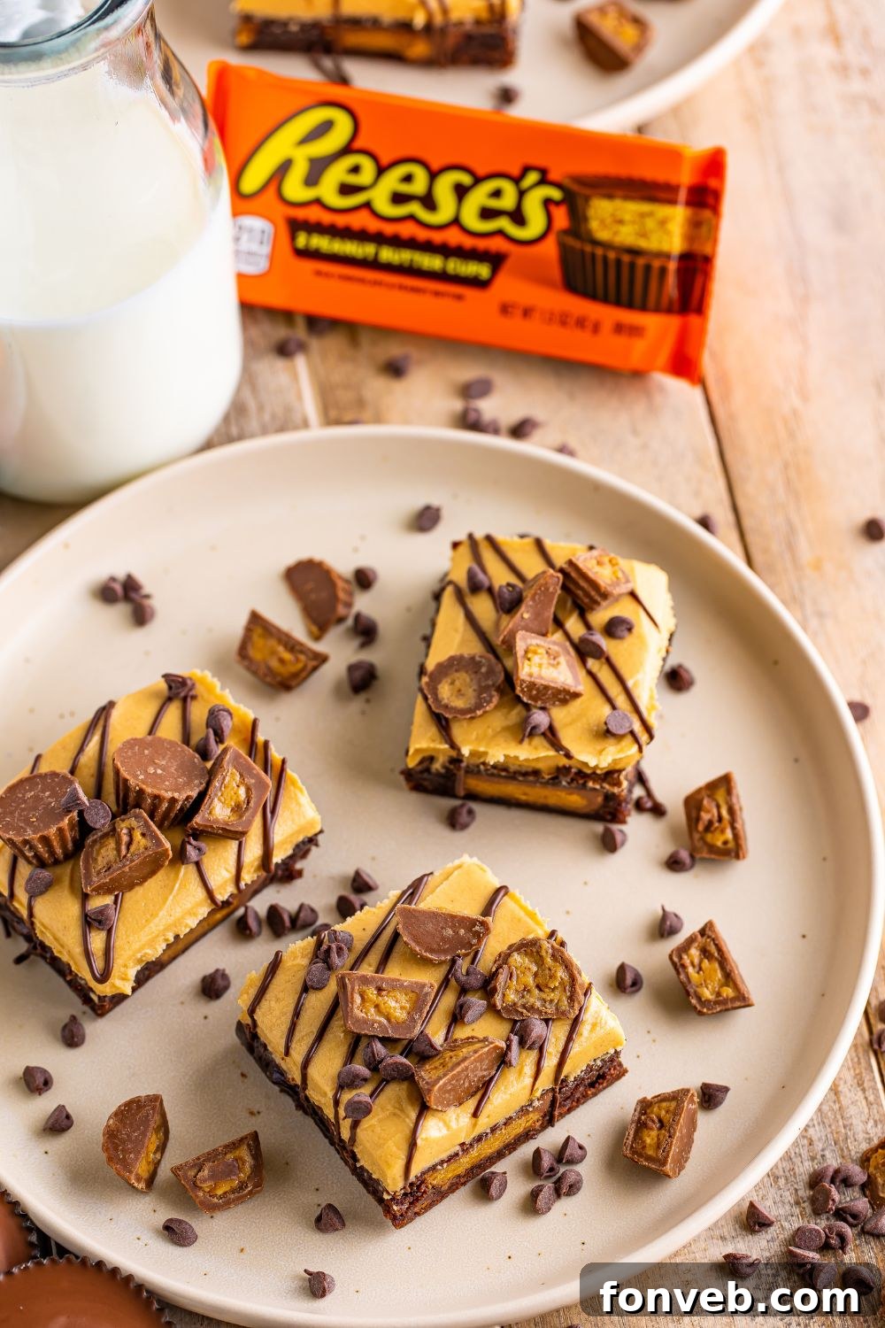 Reese's Stuffed Brownies presented on a plate, with a container of Reese's cups and a glass of milk in the background, creating an inviting scene