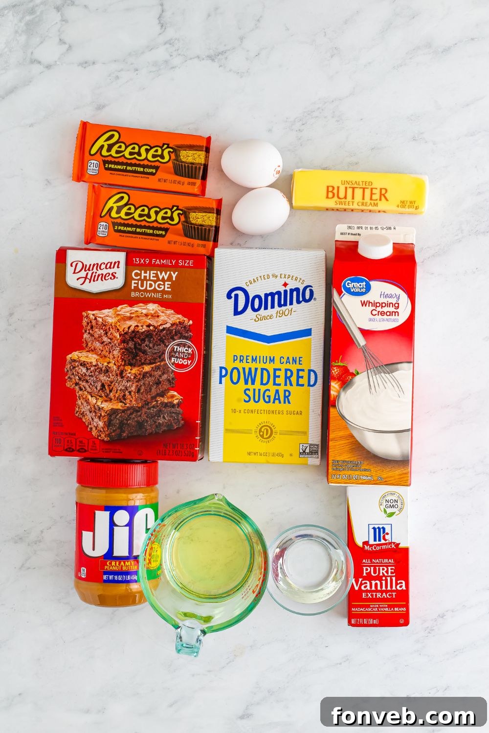 A collection of ingredients for Reese's Stuffed Brownies, neatly displayed in various containers on a rustic wooden table, ready for baking