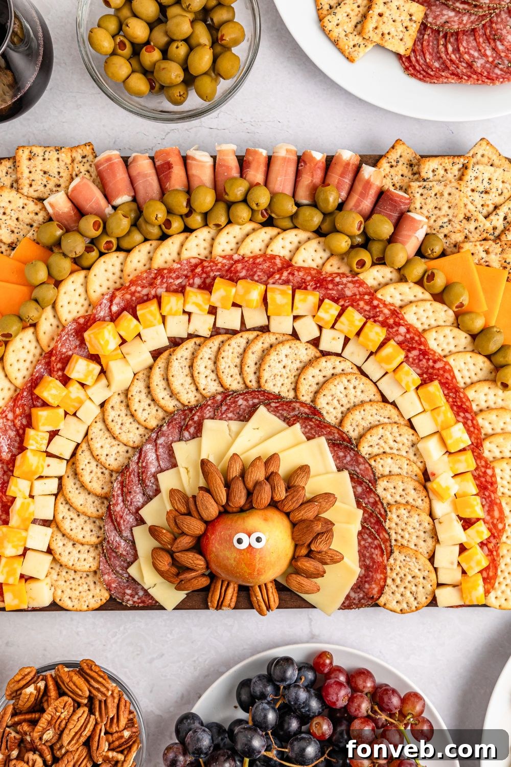 Turkish Bites Board 11 Turkey Snack Board on table with bowls of olives, plate of grapes and more around the snack board