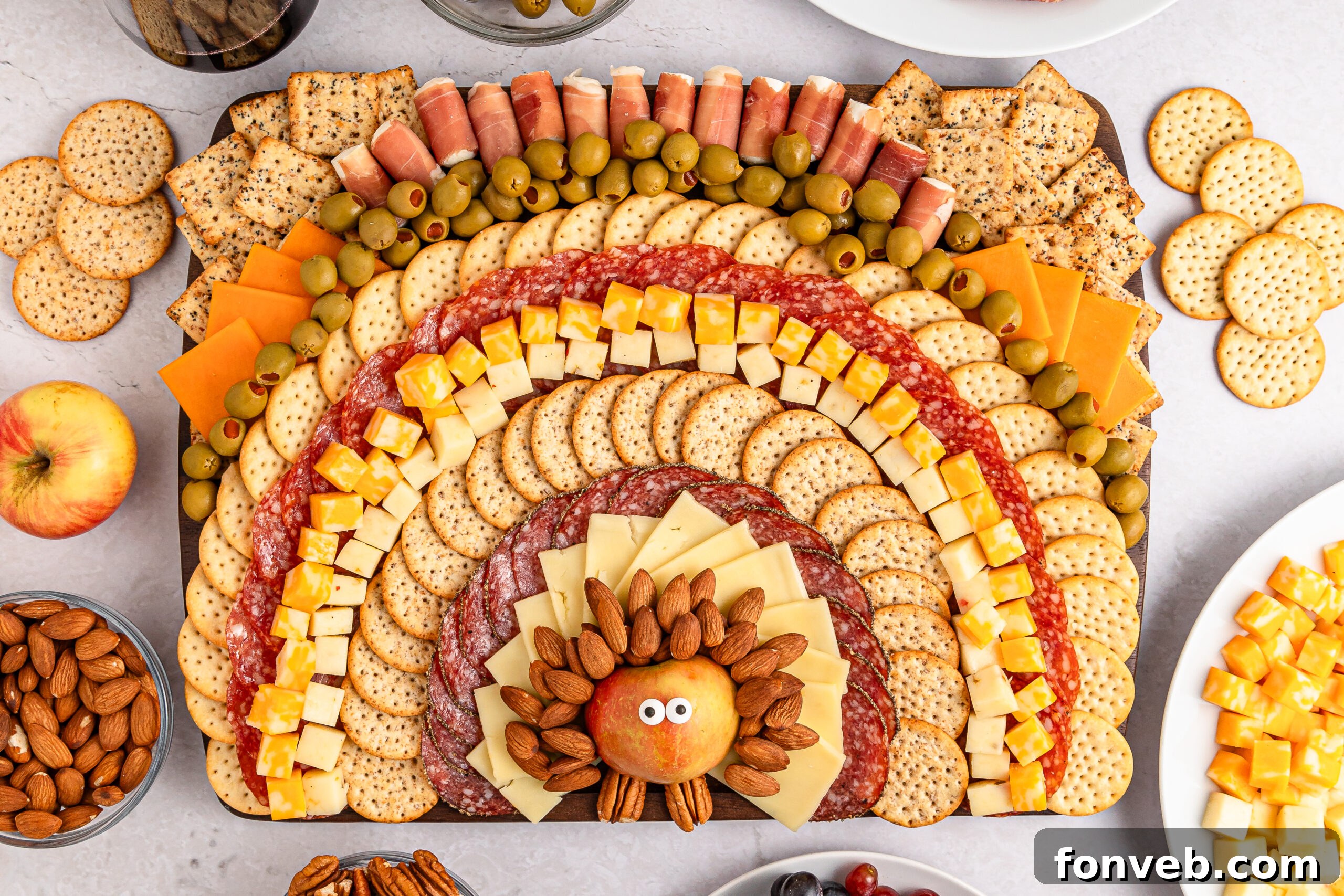 Turkish Bites Board 17 Turkey Snack Board that looks like a turkey and feathers made with meat cheese and more on a platter sitting on table