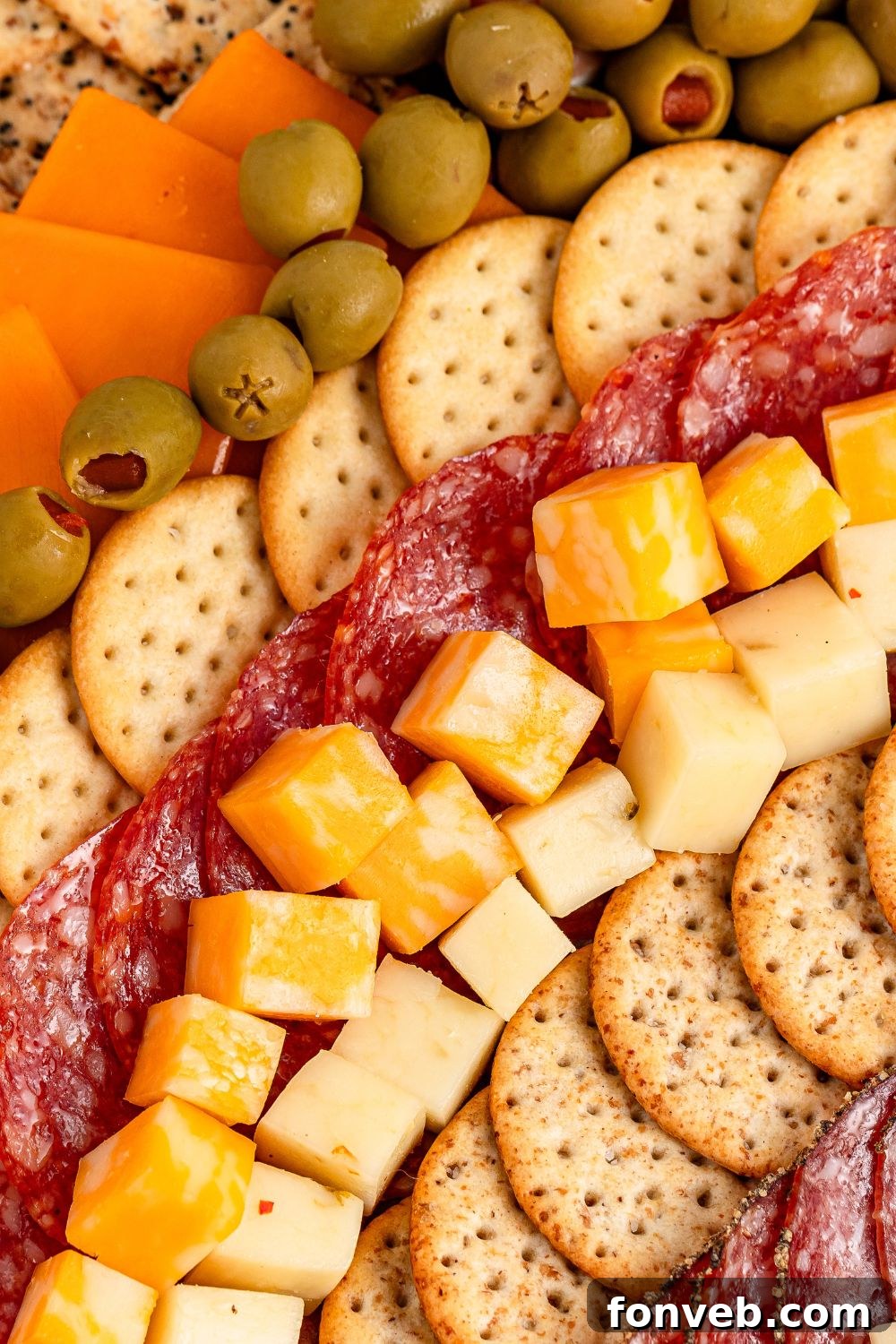 Turkish Bites Board 5 cheese, crackers, meats all in rows on table for a charcuterie board