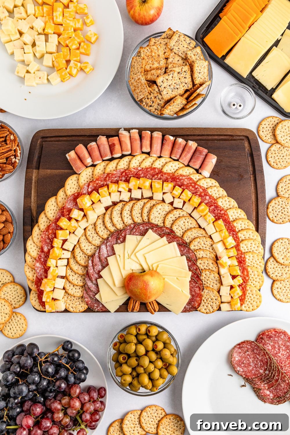 Turkish Bites Board 8 cheese and crackers being spread on board to make this Turkey Snack Board