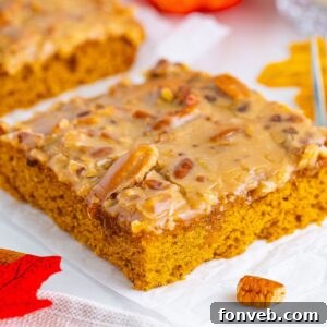slice of Pumpkin Snack Cake with Praline Icing sitting on a napkin on table