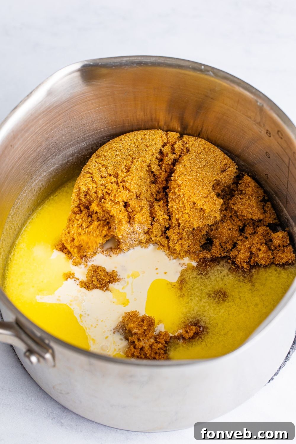 All the ingredients for the rich praline frosting simmering in a saucepan on the stovetop, ready to be transformed.