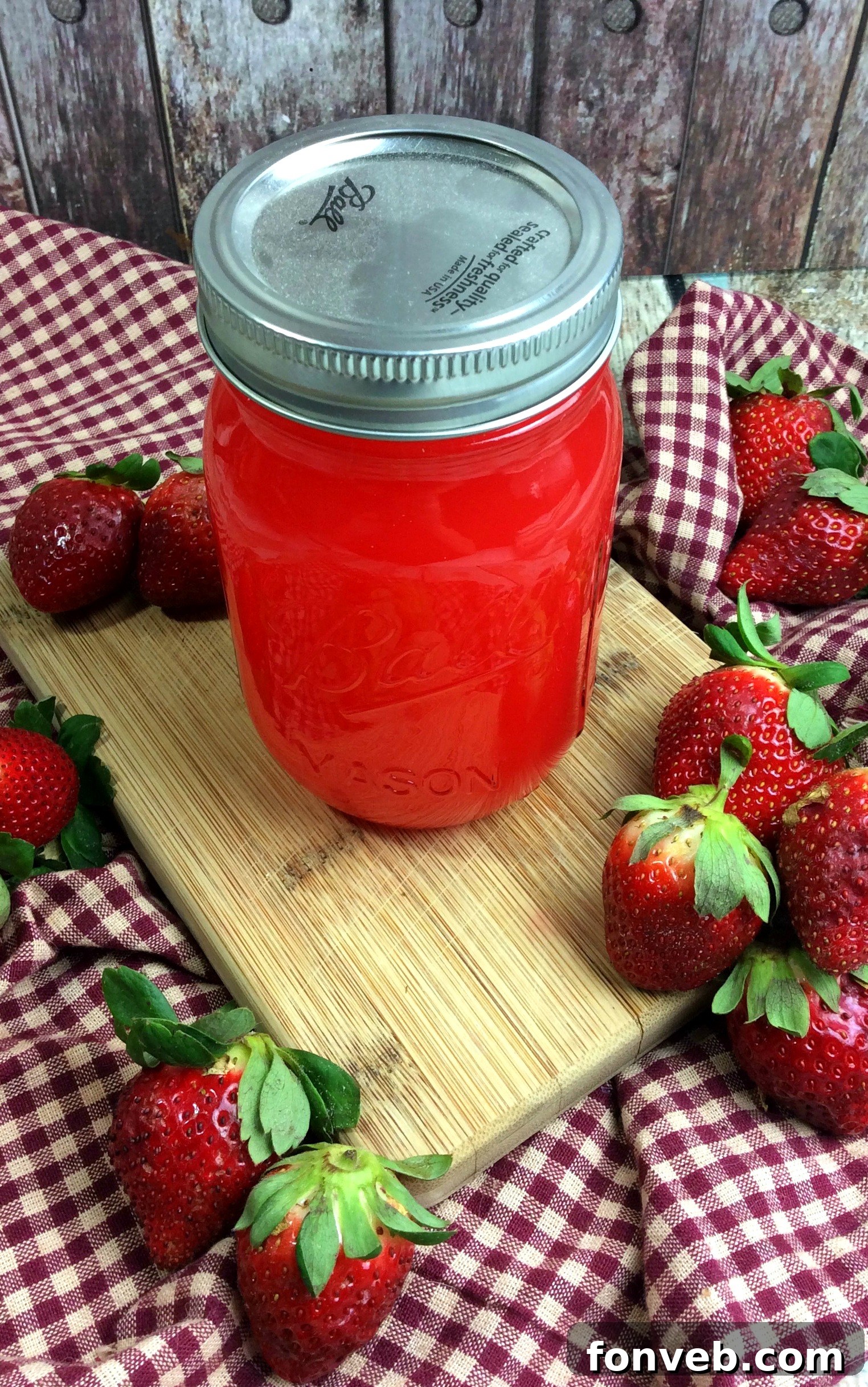 Large pot on a stovetop, symbolizing the start of a homemade strawberry moonshine recipe