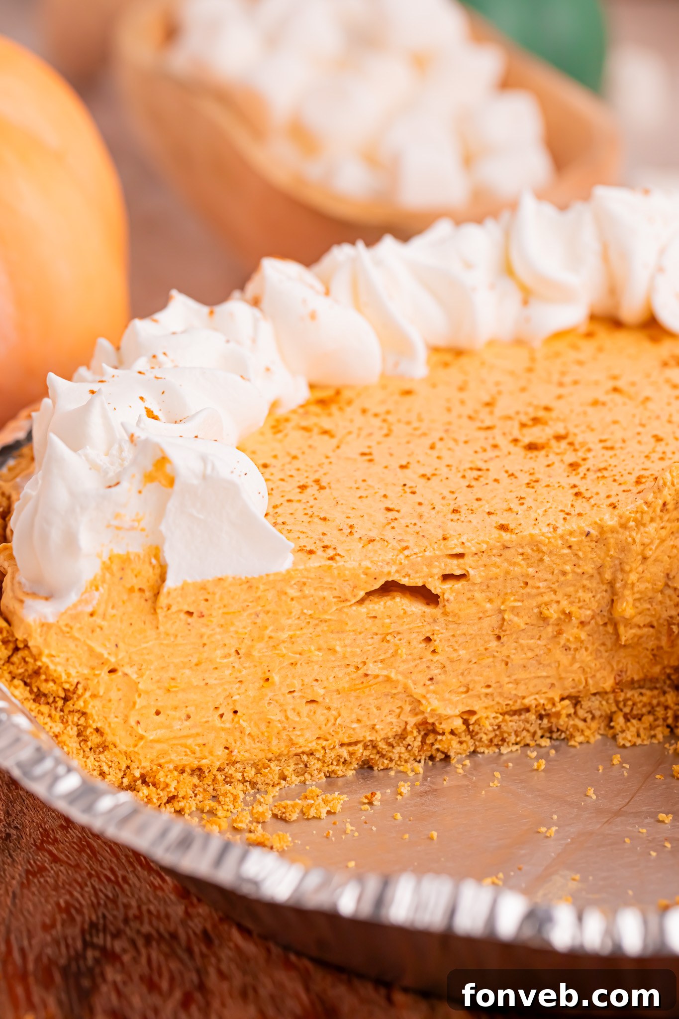 Marshmallow Pumpkin Pie in a pie dish with a slice removed 