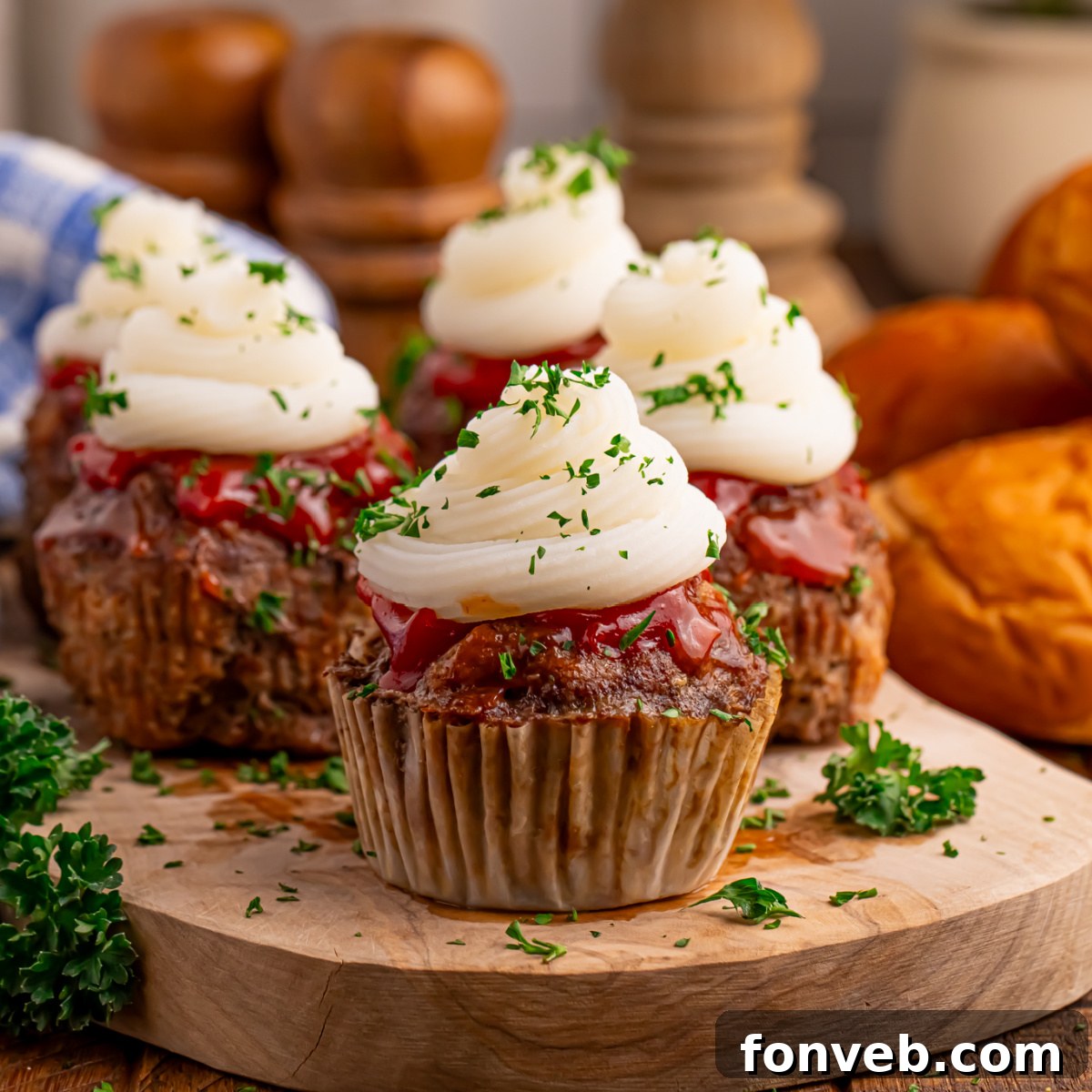Meatloaf Cupcakes sitting on a wooden cutting board