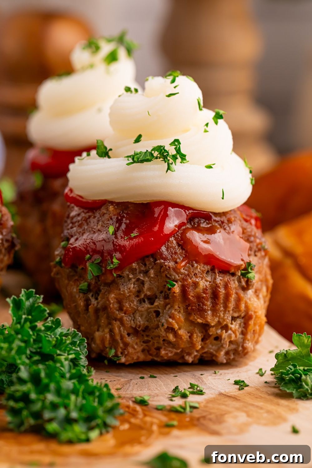 Meatloaf Cupcakes sitting on table with some parsley around it 