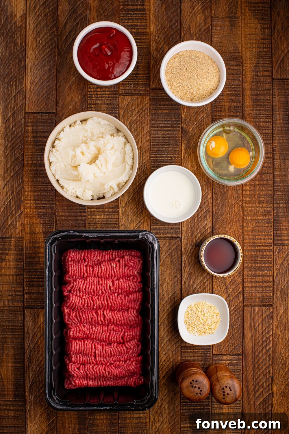 ingredients to make Meatloaf Cupcakes on table: raw beef, egg, milk, breadcrumbs, ketchup, and more