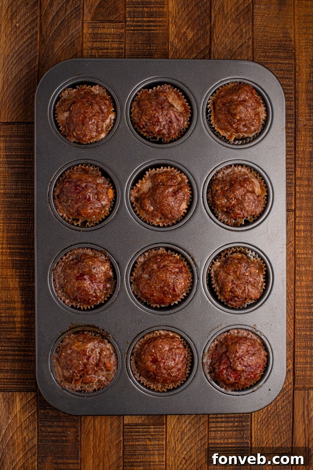 cooked meatloaf in a cupcake tray sitting on the table