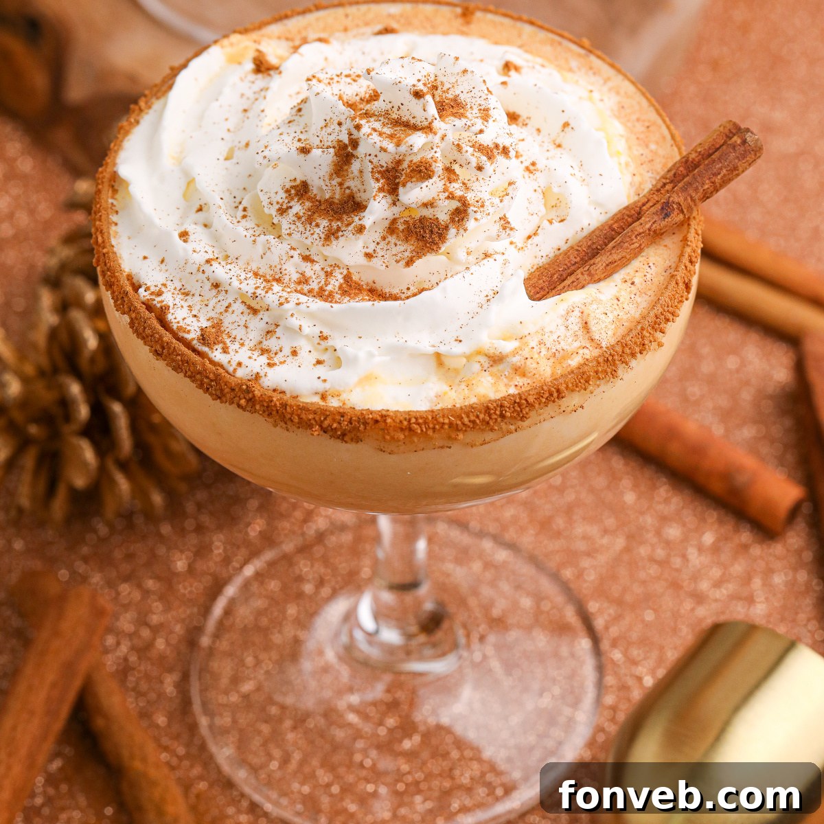 A single glass of pumpkin martini elegantly sits on a table, ready to be enjoyed, showcasing the simplicity and allure of the drink.