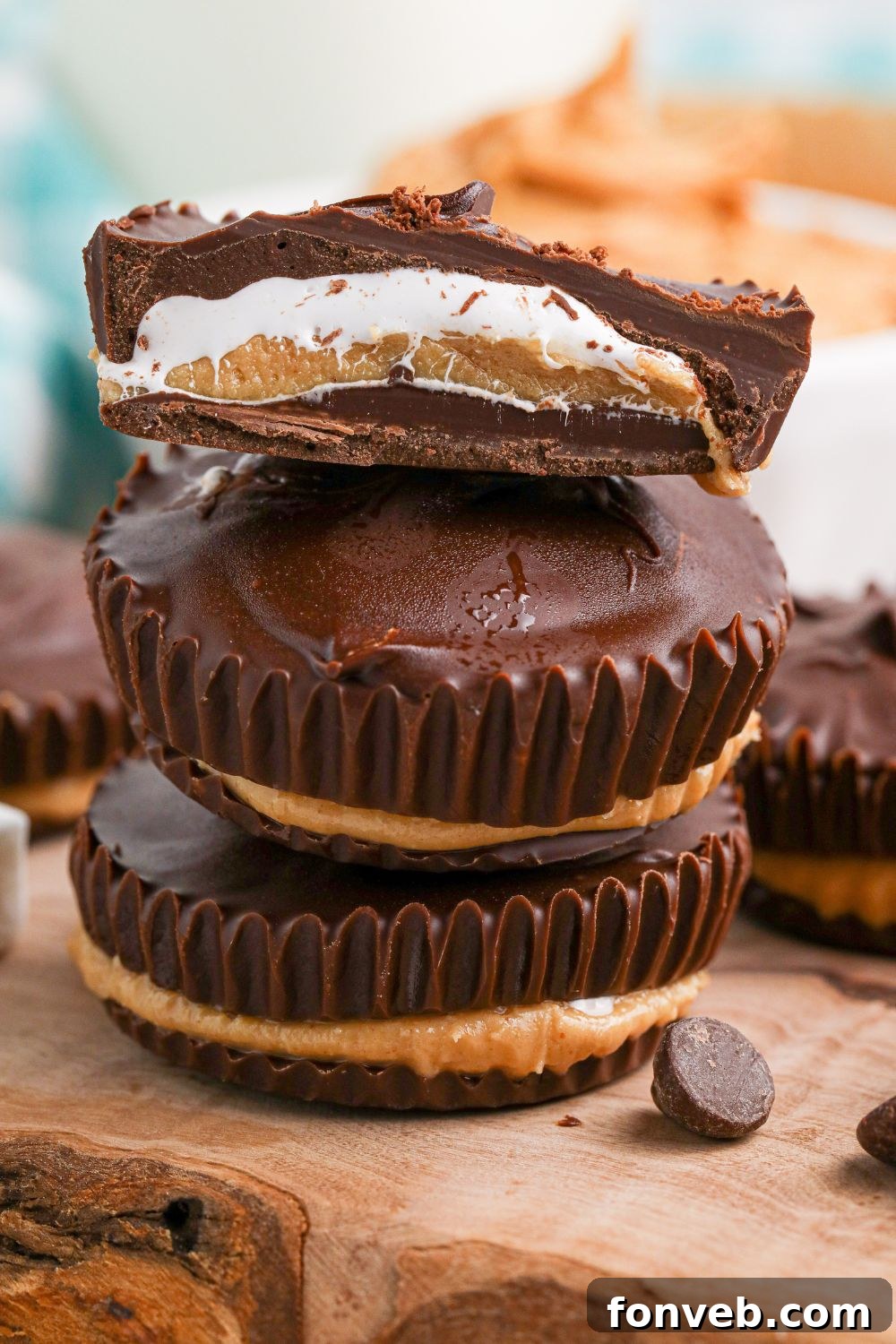 Peanut Butter Fluff Cups 16 Peanut Butter Marshmallow Cups stacked on top of one another and a close up of top one cut in half to see layers of filling