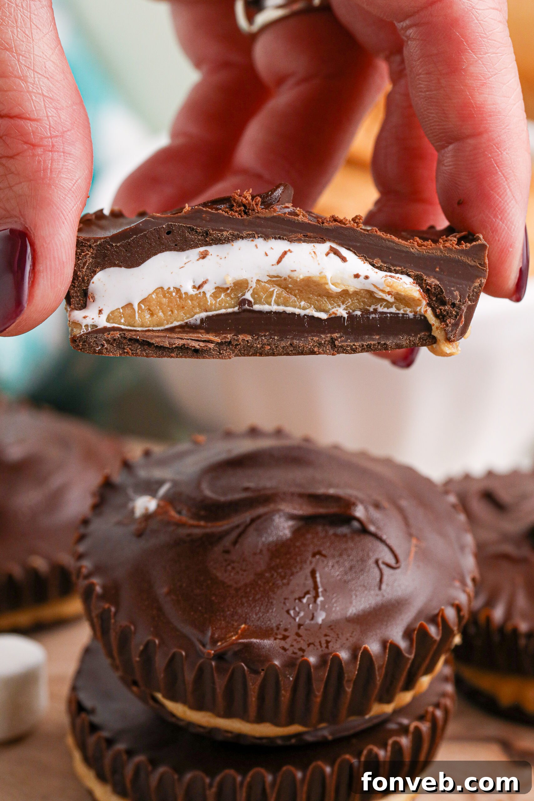 Peanut Butter Fluff Cups 17 Hand holding a cut open marshmallow peanut butter cup showing the inside