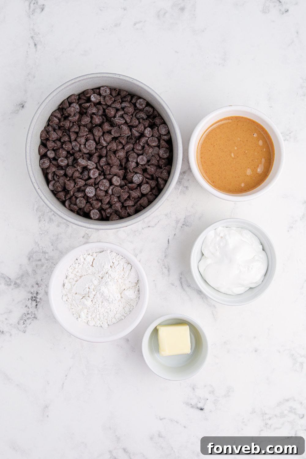 Peanut Butter Fluff Cups 4 ingredients for Peanut Butter Marshmallow Cups in bowls sitting on marble counter