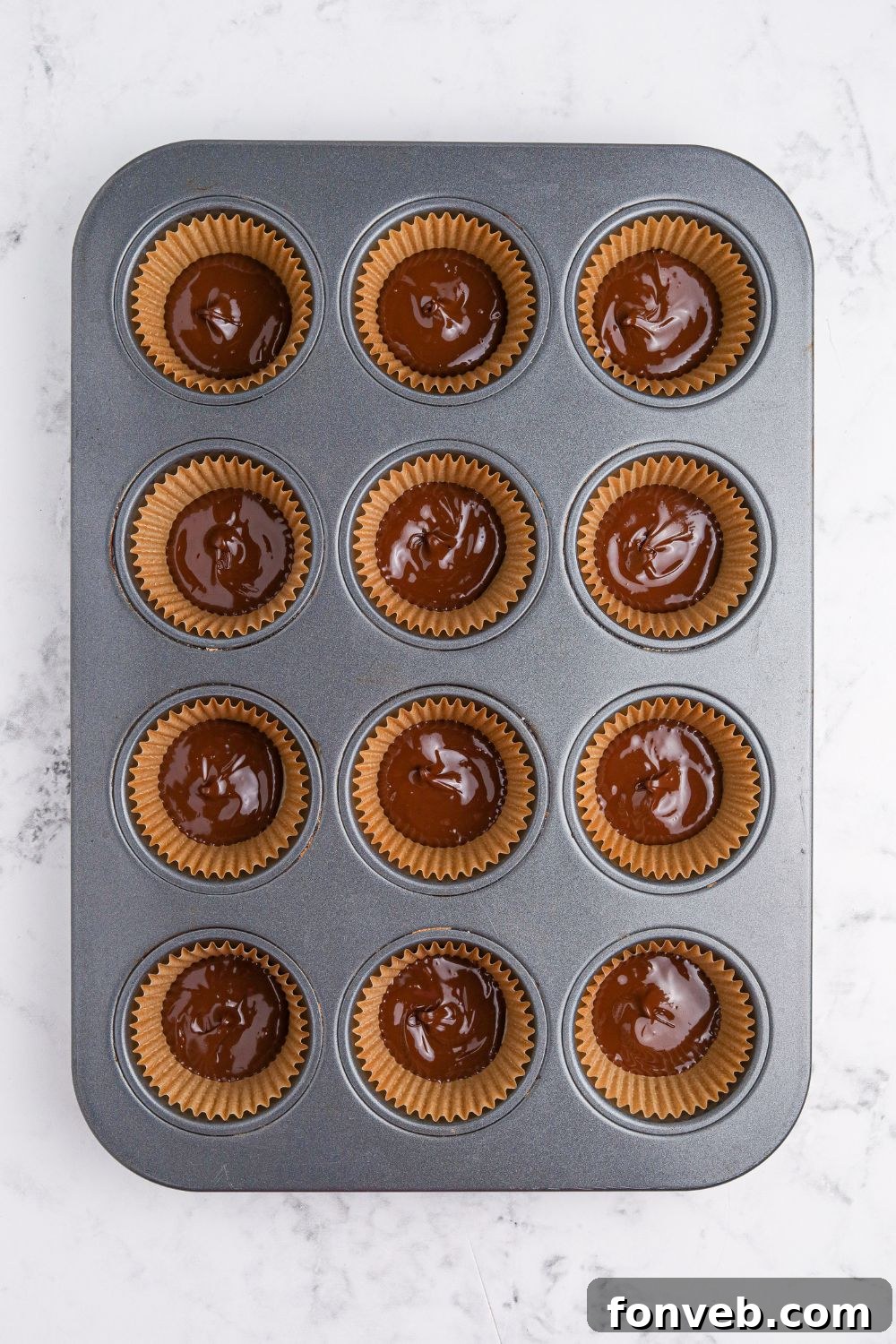 Peanut Butter Fluff Cups 6 chocolate poured into muffin cup with a liner to make Peanut Butter Marshmallow Cups