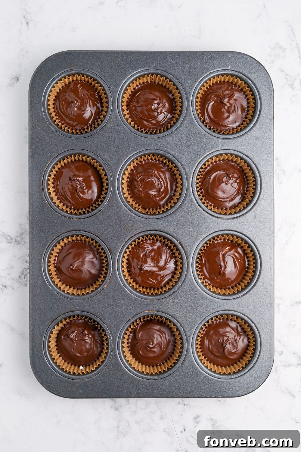 Peanut Butter Fluff Cups 9 wet chocolate in muffin tin for making Peanut Butter Marshmallow Cups