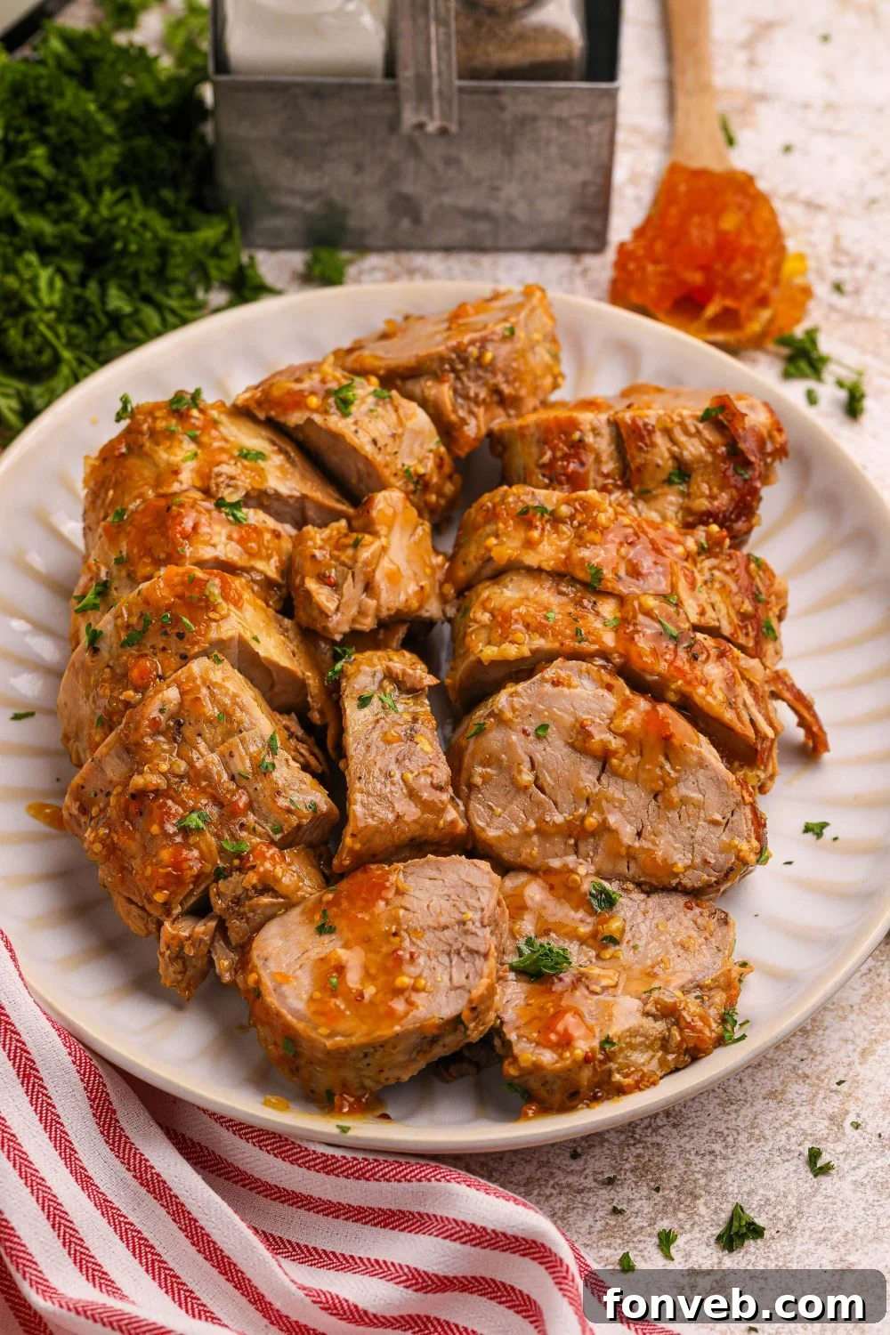 pork tenderloin with apricot sauce sliced and placed on a platter on table