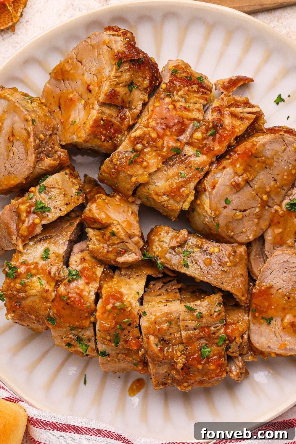 Apricot Pork Tenderloin sliced and placed on a platter on table 