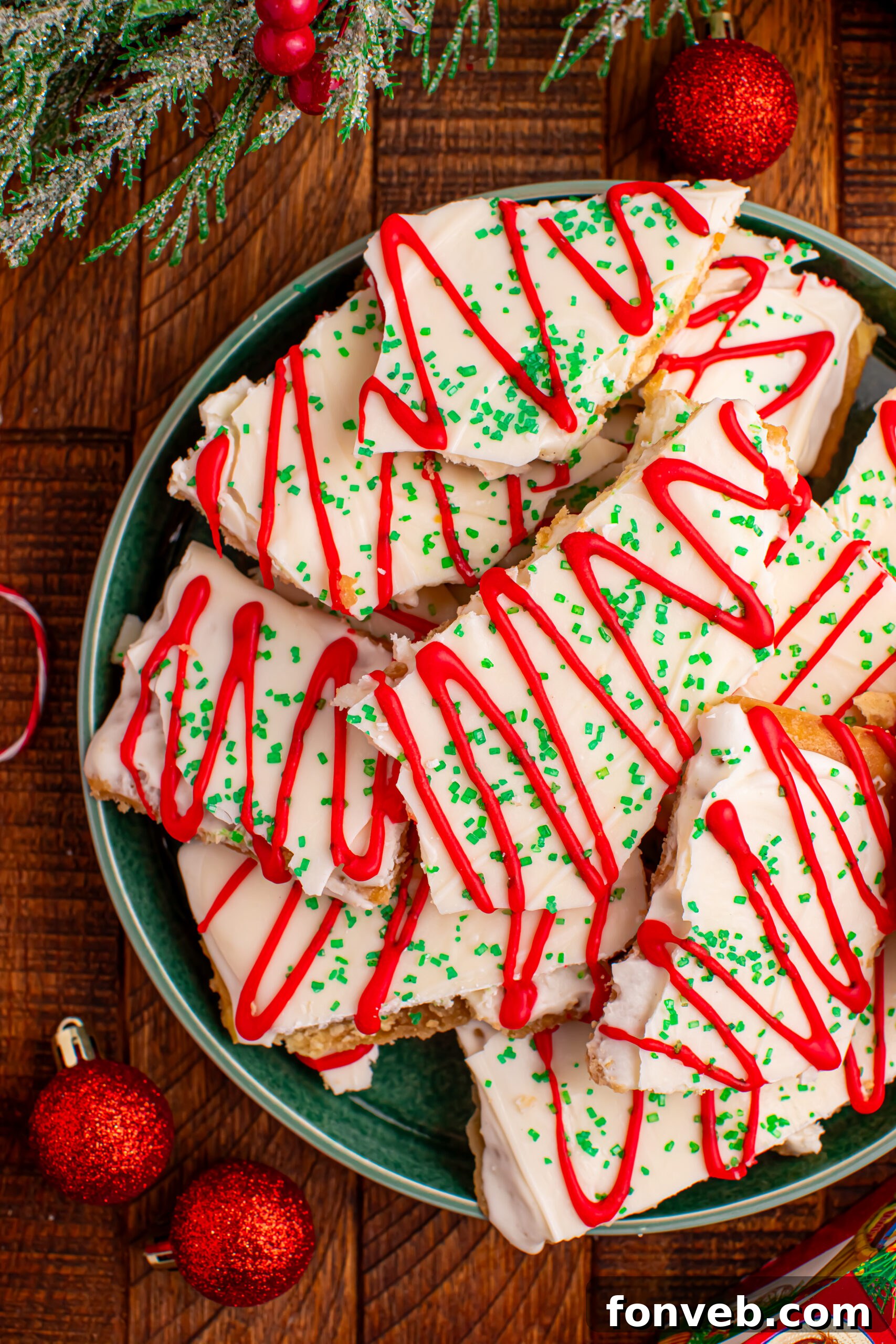 Addictive Little Debbie Christmas Tree Cake Toffee Bark 17 Close up overhead photo of Christmas Tree Crack piled on a green serving platter