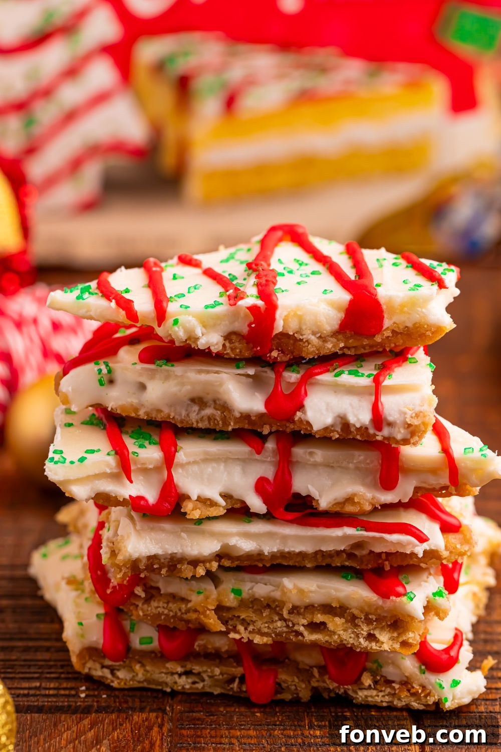 Addictive Little Debbie Christmas Tree Cake Toffee Bark 9 Christmas Tree Crack stacked on table with a box of Little Debbie cakes behind it