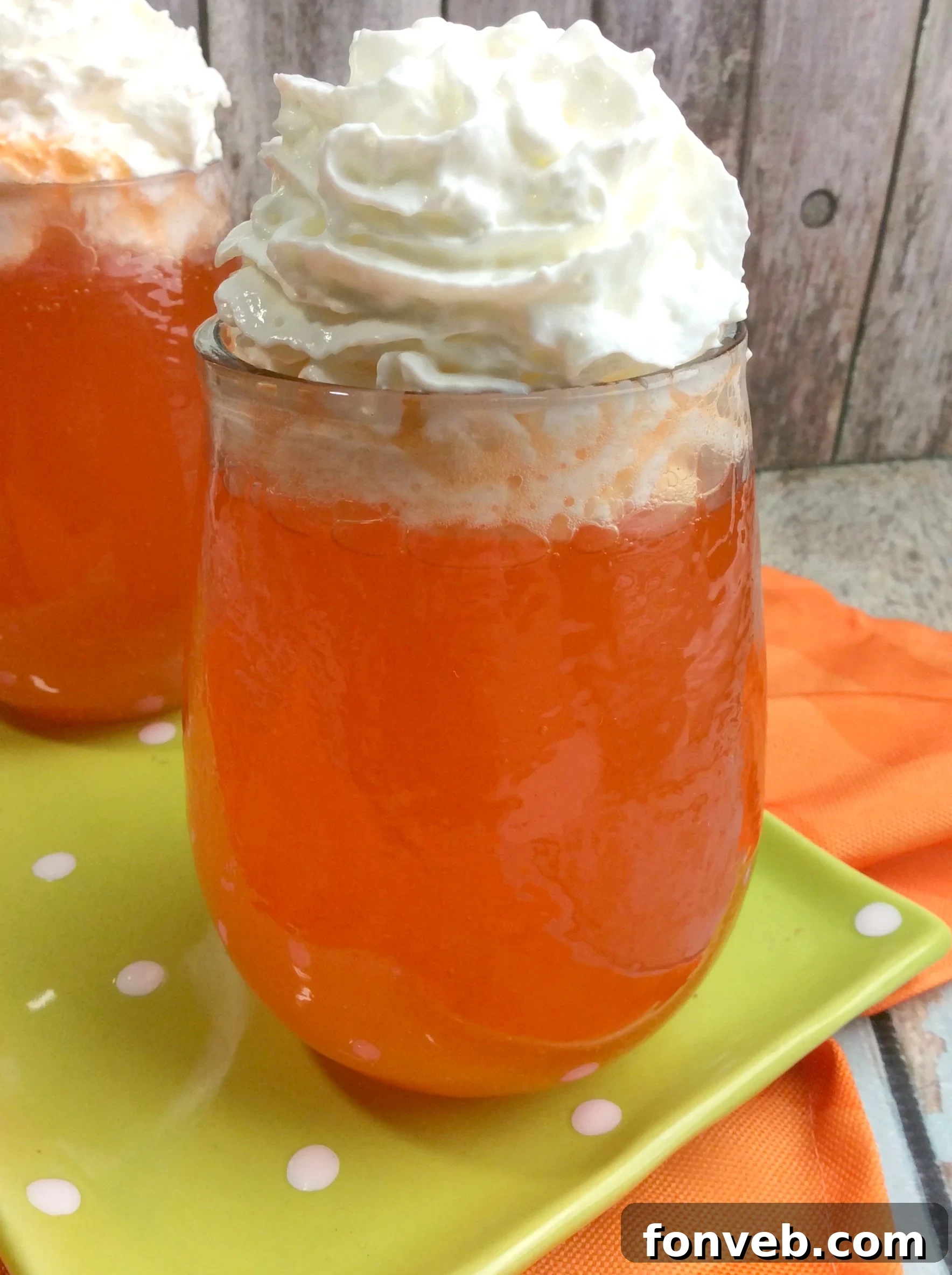 Refreshing Orange Creamsicle Cocktail in a tall glass, garnished with a slice of orange