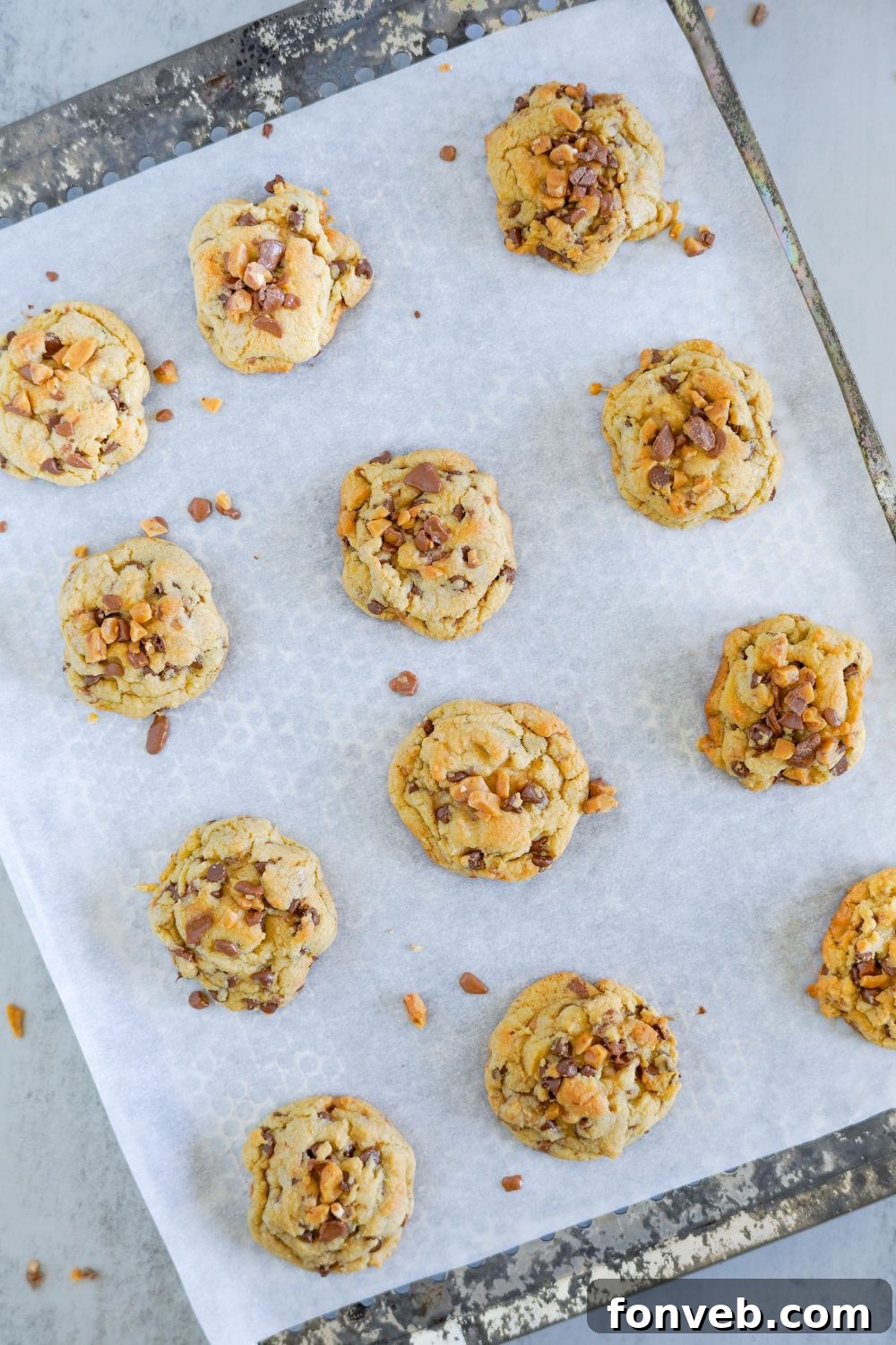 baked Chocolate Chip Toffee Cookies on a baking sheet on table 
