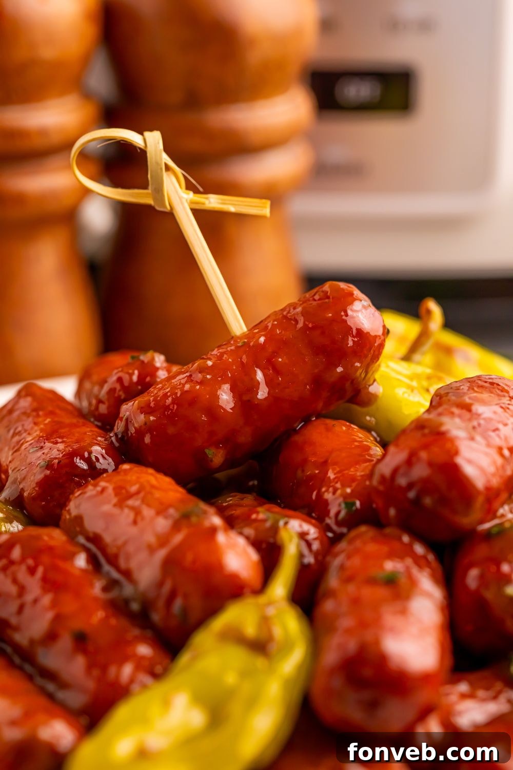 cocktail sausages stacked on table with peppers