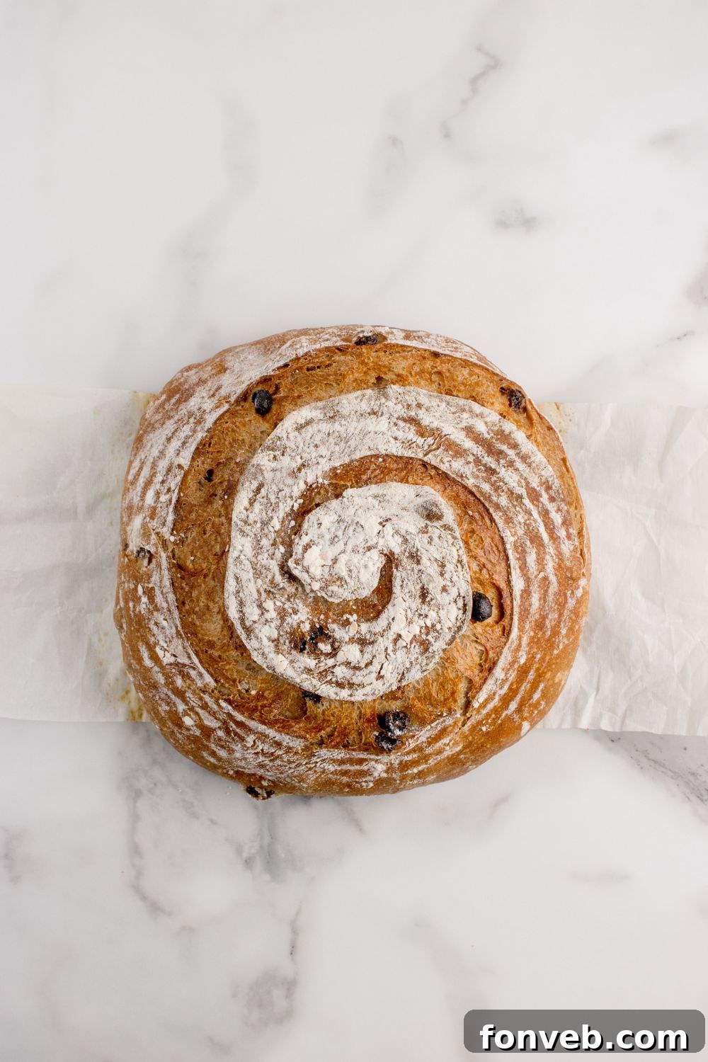 cinnamon raisin bread sitting on a marble countertop